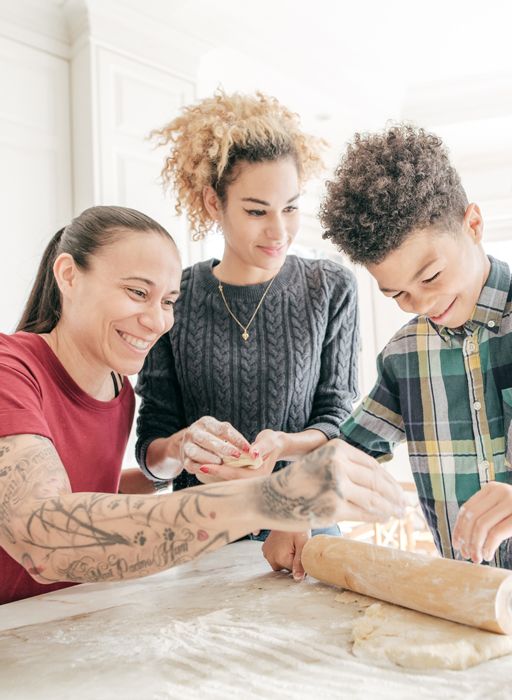 Two mothers baking with young son