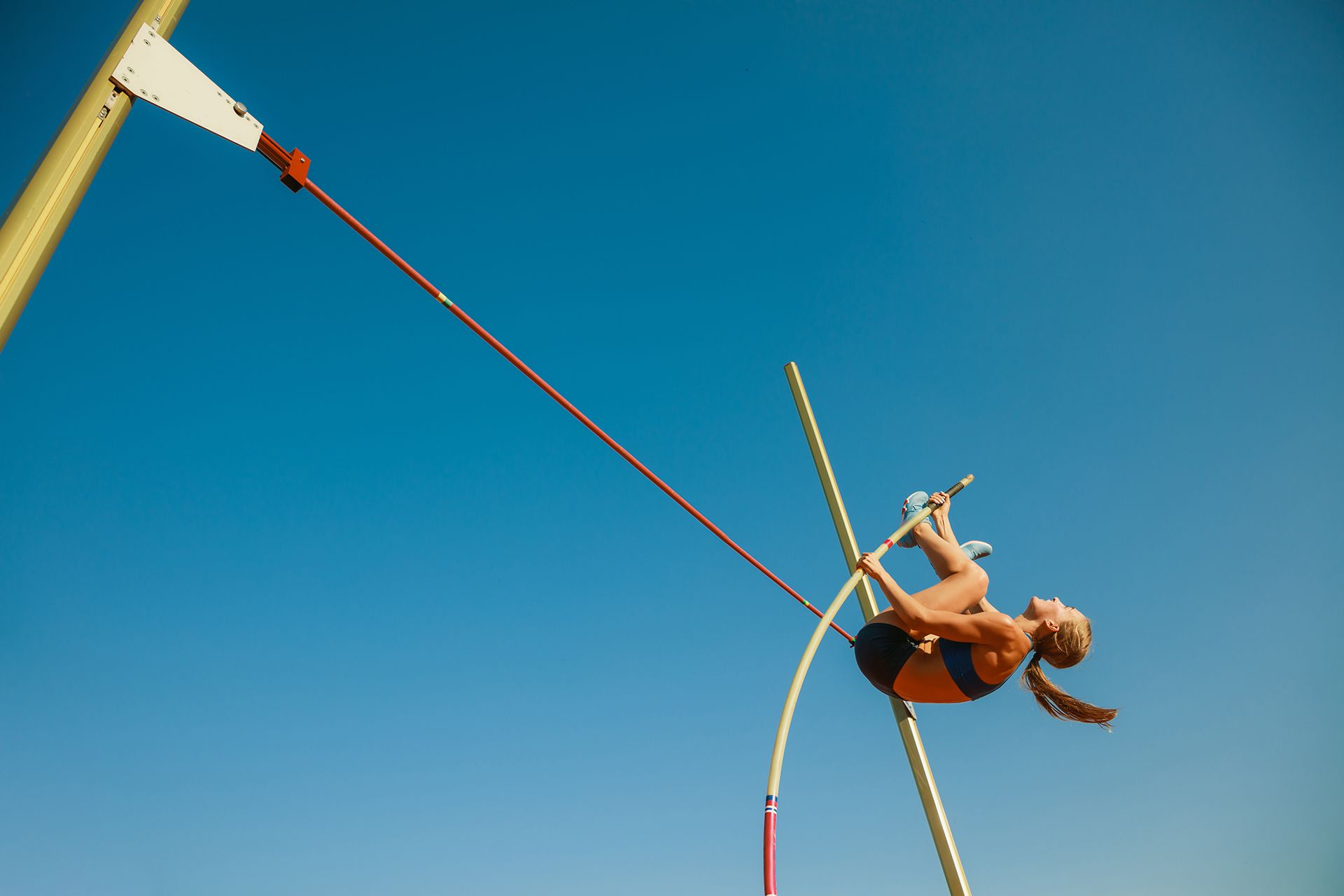Young man performing rock climbing hold.